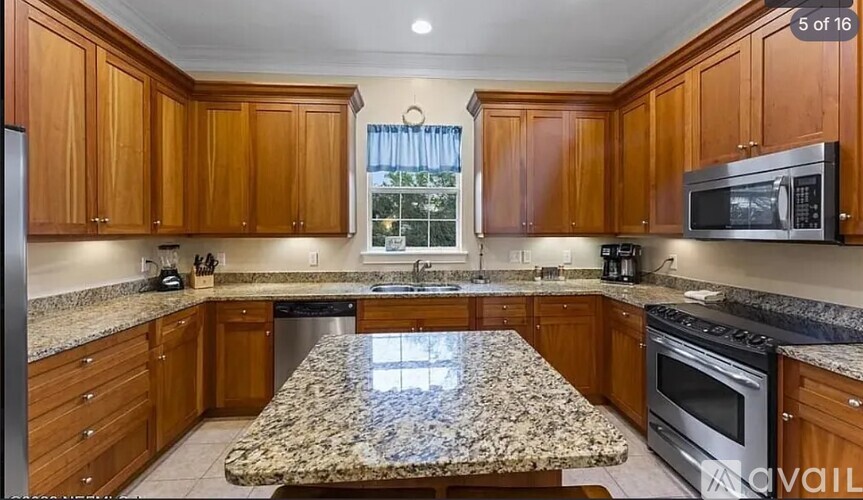 A kitchen with wooden cabinets and granite countertops.