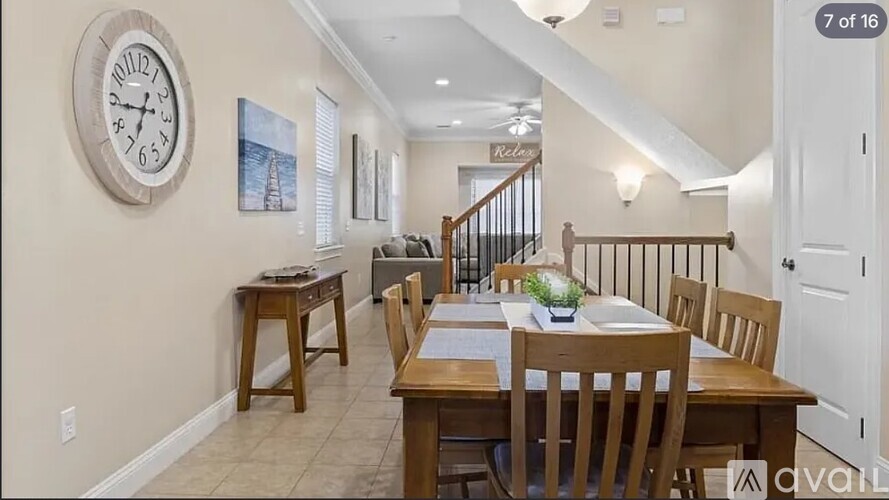 A dining room with a wooden table and chairs.