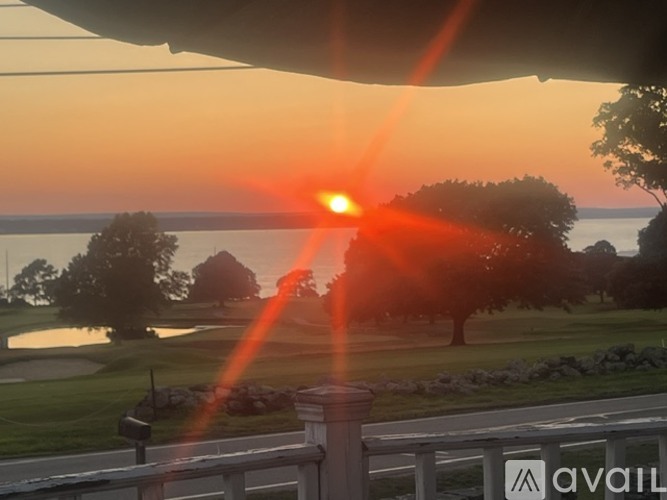 The sun is setting over a golf course.