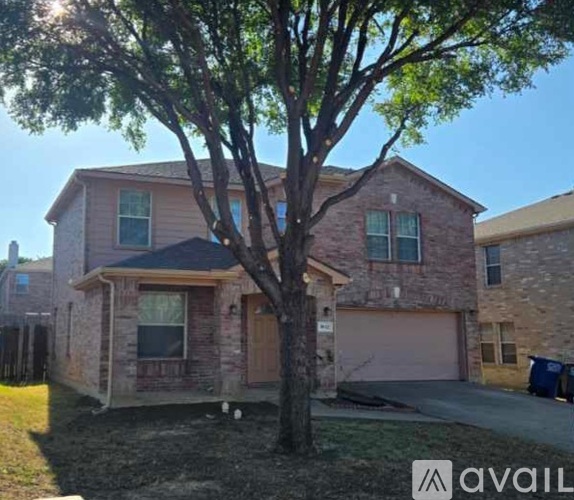 A house with a tree in front of it.