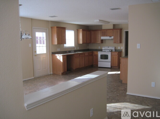 A kitchen with wooden cabinets and a white stove top oven.