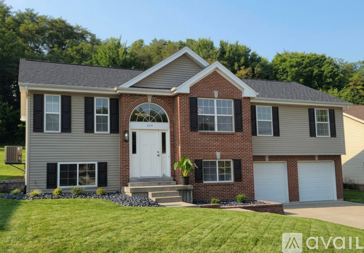 A two-story house with a brick facade and a white door.