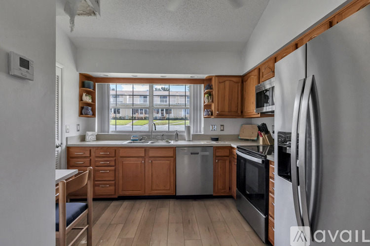 A kitchen with wooden cabinets and stainless steel appliances.