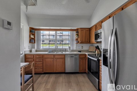 A kitchen with wooden cabinets and stainless steel appliances.