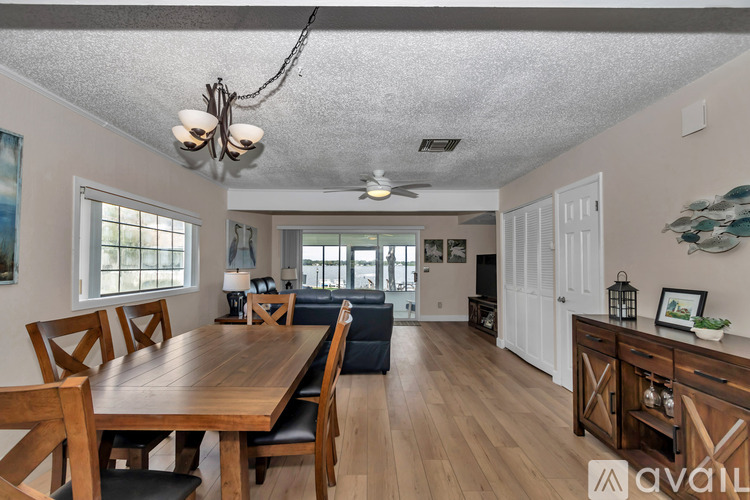 A dining room with a wooden table and chairs.
