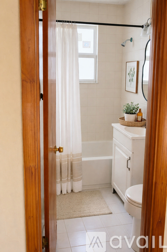 A bathroom with a toilet, sink and shower.