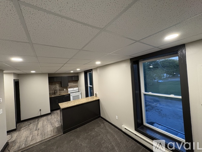 A spacious office with a window overlooking a street.