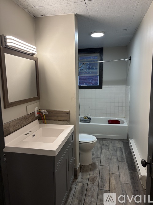 A bathroom with a white sink and a white toilet.