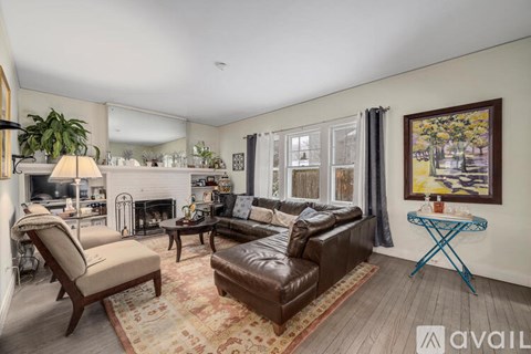 A living room with a brown leather couch and a blue metal table.