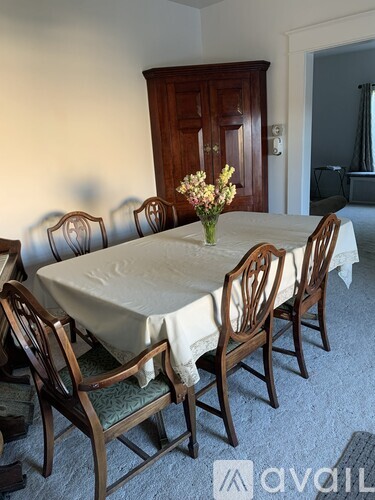 A dining room with a table set for six.