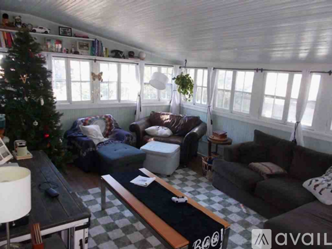 A living room with a Christmas tree and a couch.