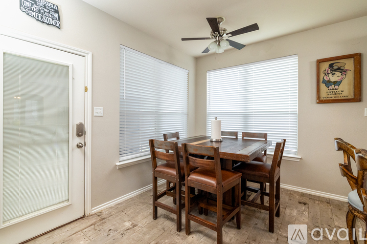 A dining room with a table and chairs.
