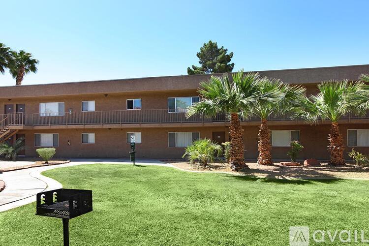 A building with palm trees in front of it.