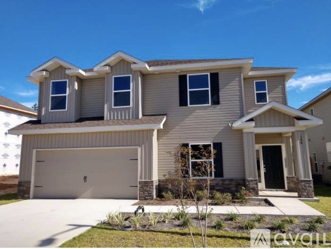 A two-story house with a garage and a front porch.
