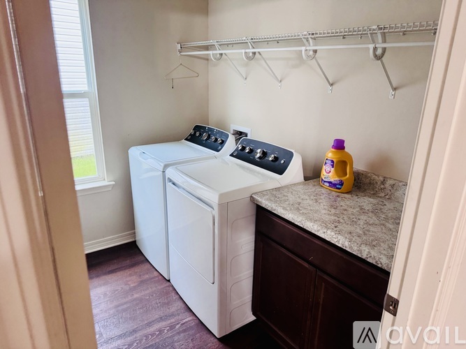 A small laundry room with a washer and dryer.