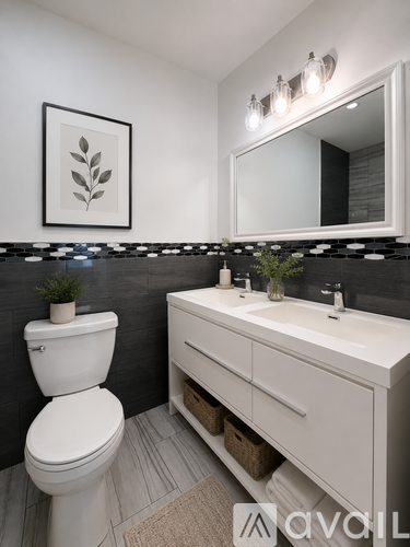 A bathroom with a white toilet and a white sink.