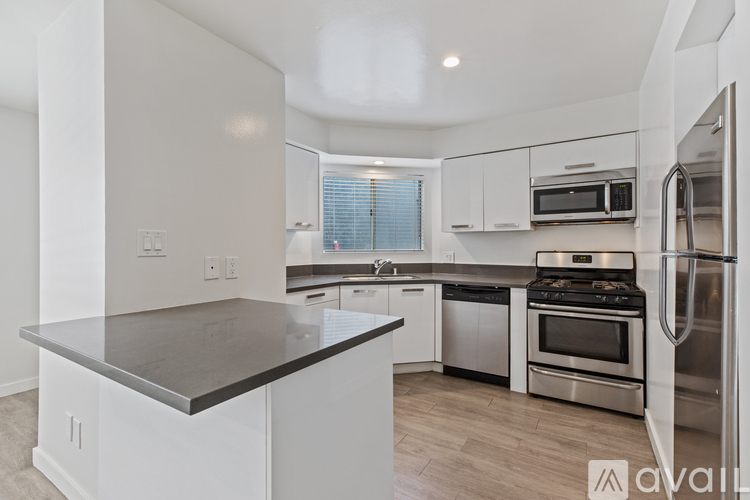 A kitchen with white cabinets and stainless steel appliances.