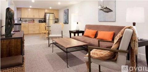 A living room with a brown couch and a wooden coffee table.