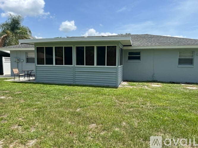 A house with a grey roof and a white garage door.