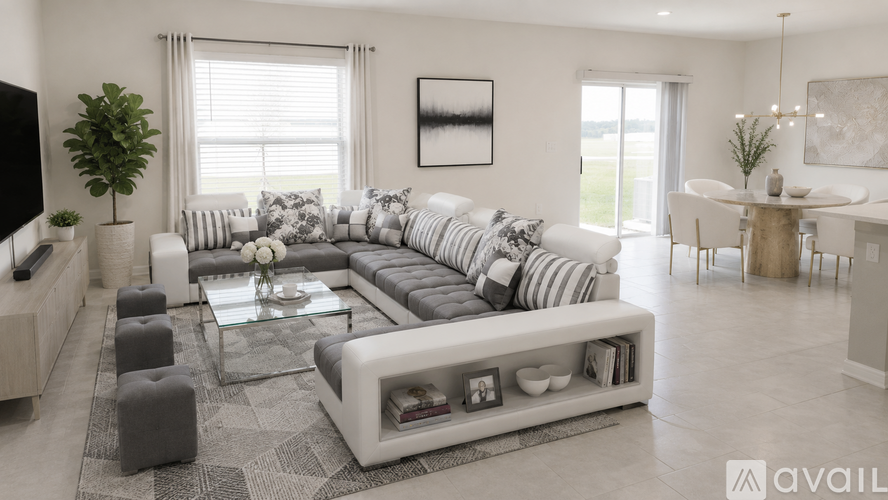 A modern living room with a large sectional sofa and a coffee table.