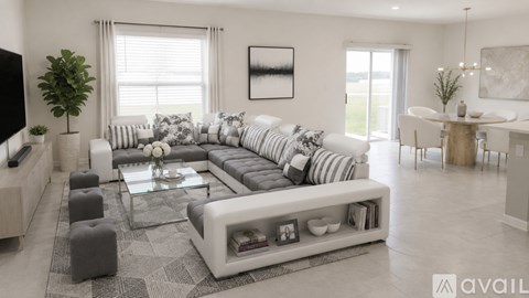 A modern living room with a large sectional sofa and a coffee table.