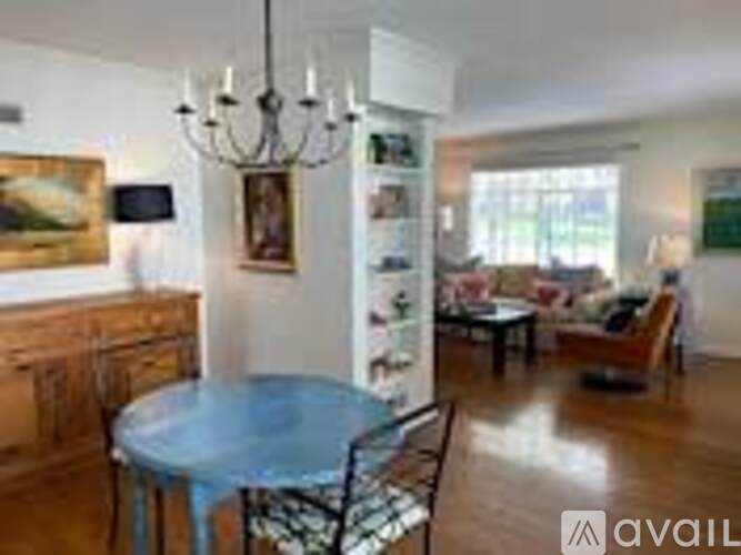 A dining room with a glass table and chairs.