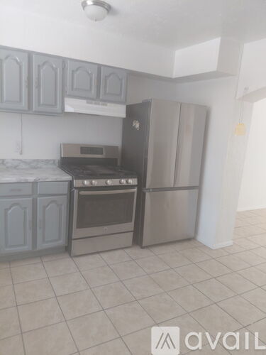 A kitchen with a stove, oven, and refrigerator.