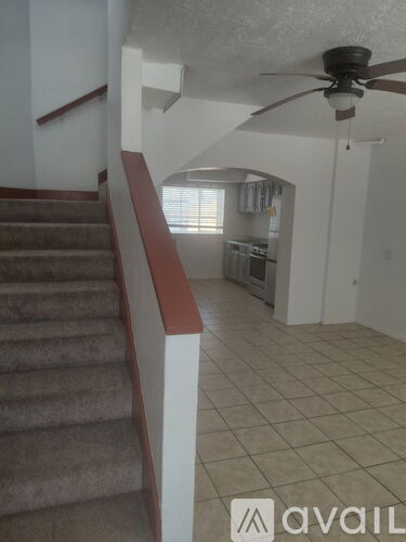 A staircase with a carpeted runner and a wooden handrail.