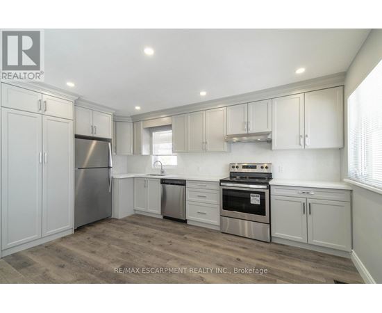 A kitchen with white cabinets and stainless steel appliances.