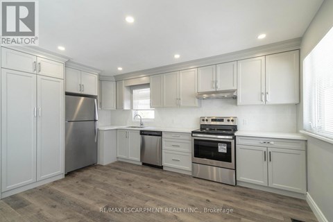 A kitchen with white cabinets and stainless steel appliances.