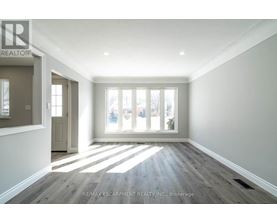 A spacious room with a view of the city through the windows.
