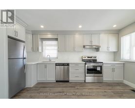 A kitchen with white cabinets and stainless steel appliances.