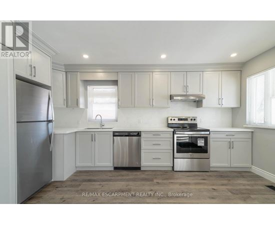 A kitchen with white cabinets and stainless steel appliances.