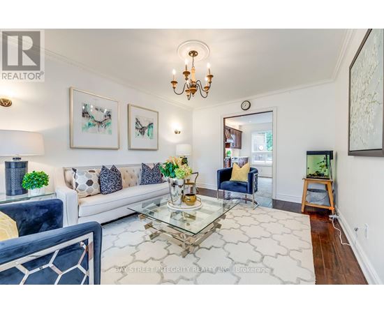 A living room with a glass coffee table and a blue couch.