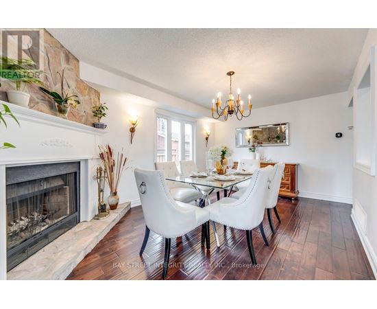 A dining room with a fireplace and a chandelier.