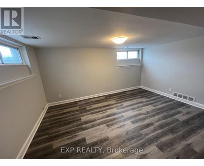 A room with wooden flooring and a window.
