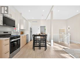 A modern kitchen with a dining table and chairs.
