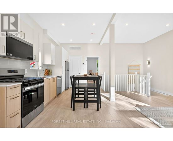 A modern kitchen with a dining table and chairs.