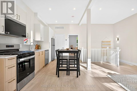 A modern kitchen with a dining table and chairs.