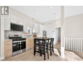 A modern kitchen with a dining table and chairs.