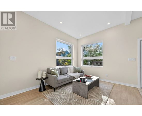 A living room with a grey couch and a coffee table.