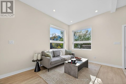 A living room with a grey couch and a coffee table.