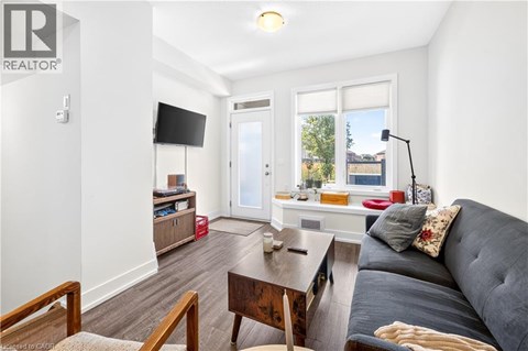 A living room with a grey couch and a wooden coffee table.