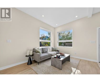 A living room with a grey couch and a coffee table.