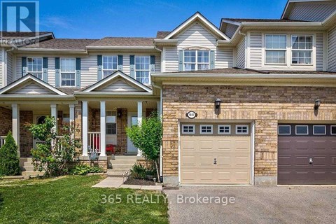 A house with a garage and a front porch is for sale.