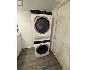 A white front loading washing machine in a laundry room.