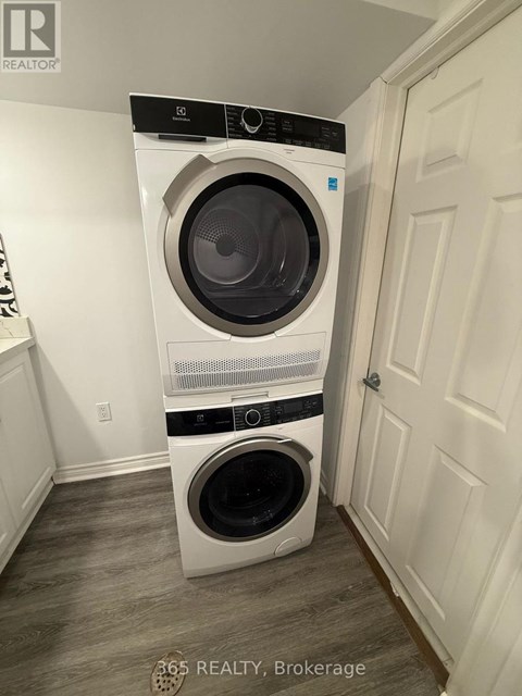 A white front loading washing machine in a laundry room.
