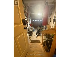 A motorcycle is parked in a garage with a door open.