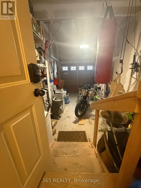 A motorcycle is parked in a garage with a door open.