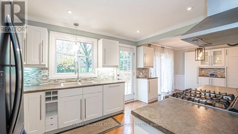 A modern kitchen with white cabinets and a large island.